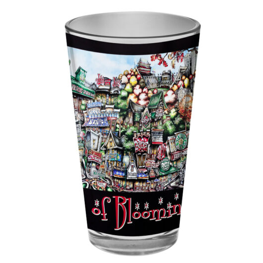 A colorful drinking glass illustrated with intricate, vibrant scenes of a bustling town, featuring buildings and local attractions.