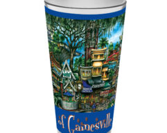 Decorative cup featuring a vibrant, detailed illustration of gainesville landmarks, with trees and historic buildings, bordered by a blue stripe.