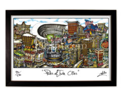 Framed illustration titled "pubs of twin cities," depicting a vibrant, cartoon-style cityscape filled with various buildings and pub signs.