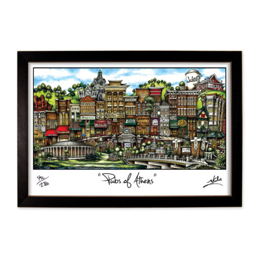 Framed artwork titled "pubs of athens," featuring a colorful and detailed illustration of various pub storefronts in an urban setting, signed by the artist.